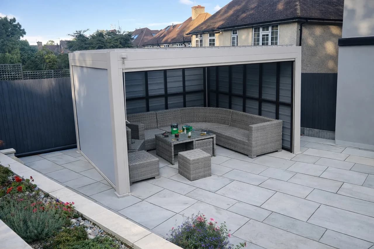 Pebble aluminium pergola with privacy screens on a landscaped patio