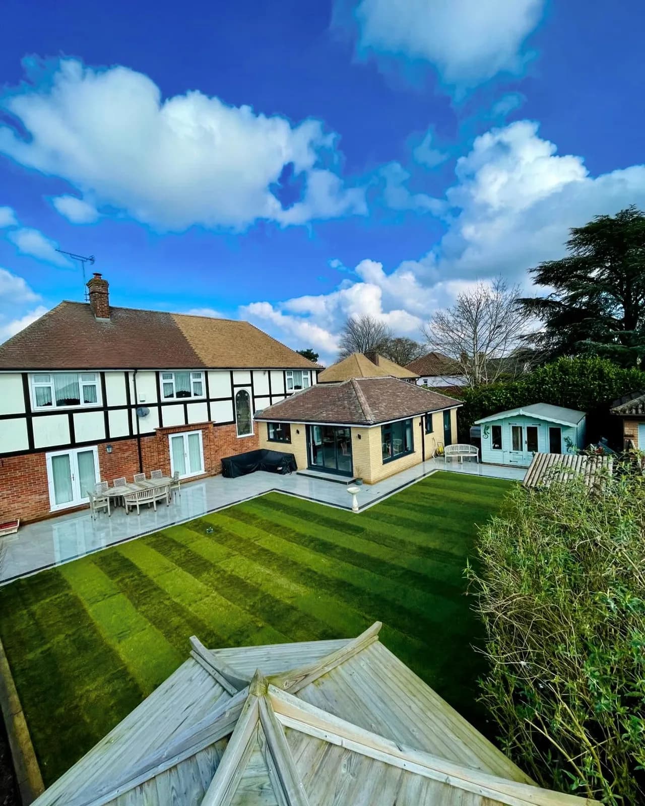 Completed garden transformation with a large porcelain patio and lawn in Cringleford