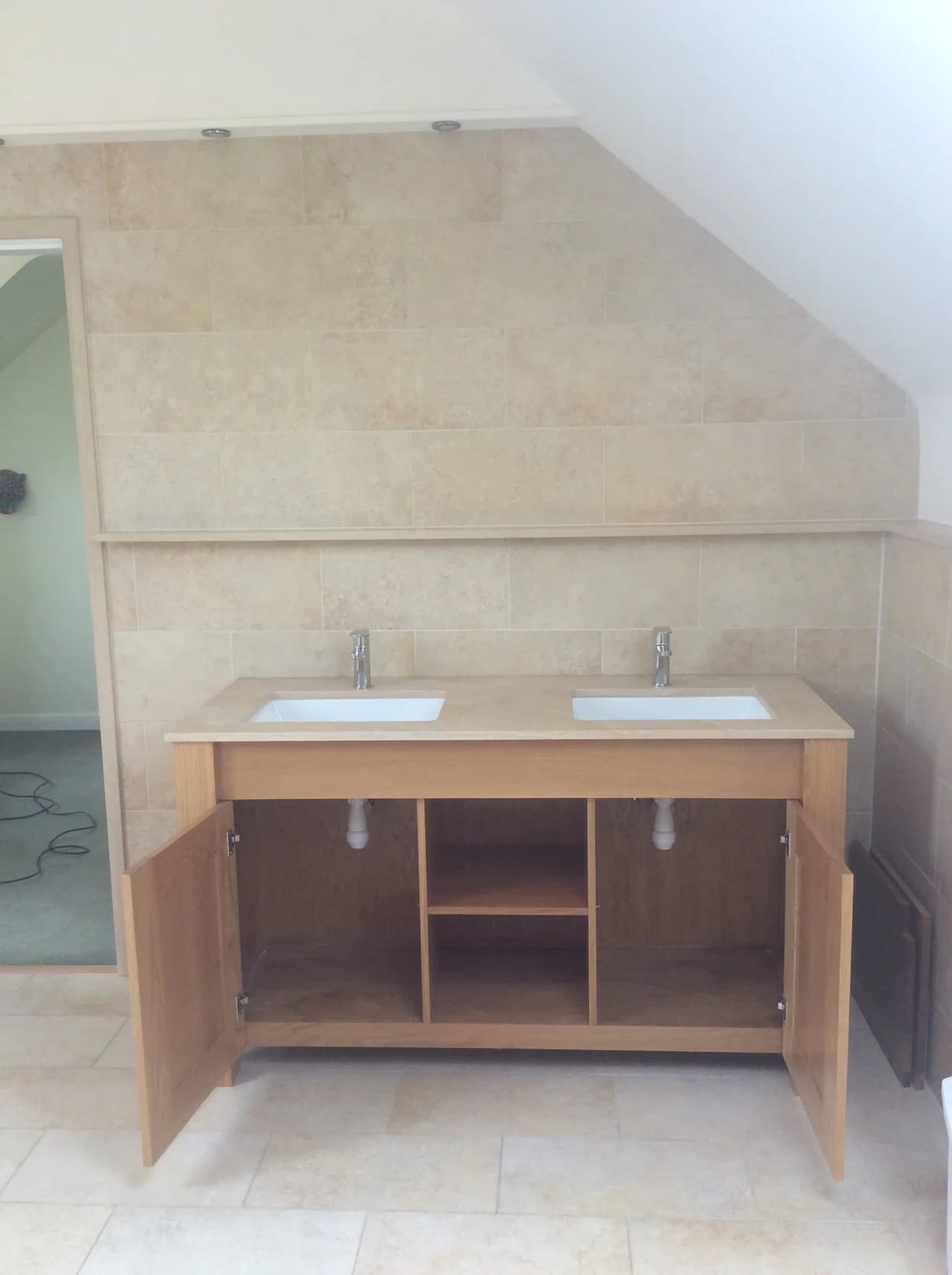 Installation of bespoke under counter sinks with stone top cut to specification.